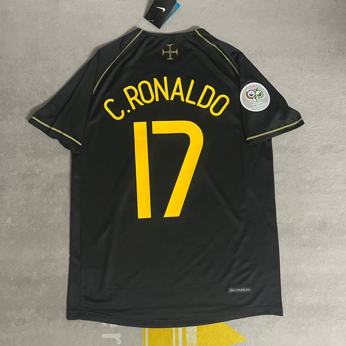 Cristiano Ronaldo's black jersey with the number 17 and the text 'Ronaldo' on the back, with a small 'CR' logo on the left chest and a UEFA Champions League patch on the right chest.